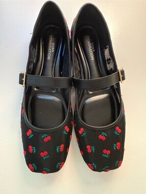 🍒 BCBG Generation Black Mary-Jane ballet flats with embroidered cherry details.